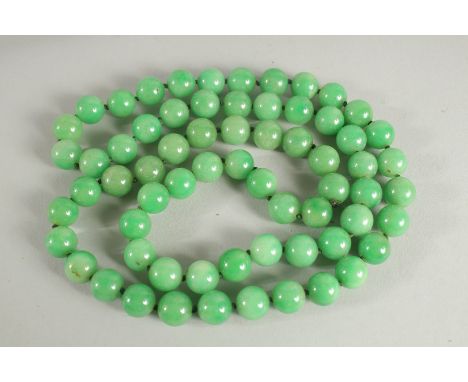 A LARGE STRING OF JADE BEADS. 34ins long.