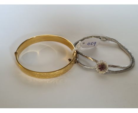 A vintage white metal bracelet set with ruby's and 9ct gold cased