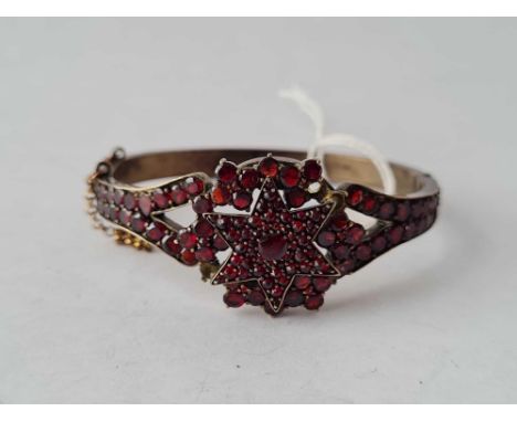 A garnet bangle some missing stones