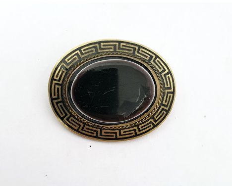 Rolled gold, black enamel and onyx brooch, oval, set single polished oval stone, flat-topped, and having Greek key border