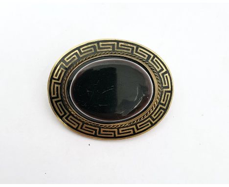 Rolled gold, black enamel and onyx brooch, oval, set single polished oval stone, flat-topped, and having Greek key border