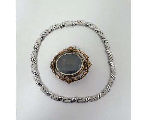 Victorian gilt metal portrait brooch pendant of oval form with central swivel double-sided glazed photographs and a Trifari t
