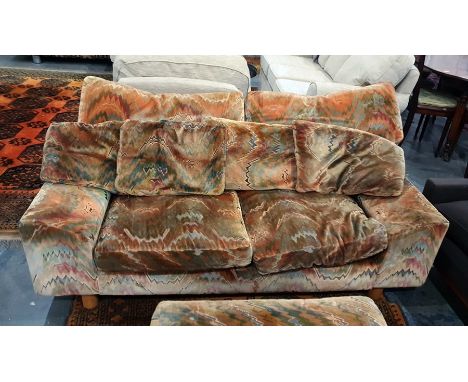 Attributed to Howard Keith 1970's pair of two-seater sofas and square pouffe in plain stitched upholstery 