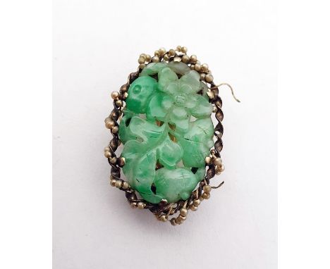 Chinese clip set with a central oval carved jade panel depicting flowers and foliage, the mount set with seedpearls and marke