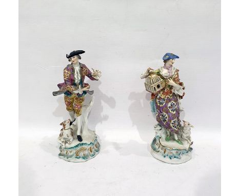 Pair of 19th century figures in the manner of Meissen, lady and gentleman with enamel painted decorative dress, the lady carr