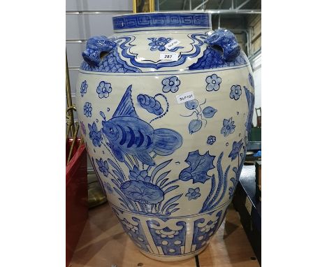 Oversized ovoid Chinese-style ceramic urn decorated in blue with fishes and dog head relief around the rim, 63cm high 