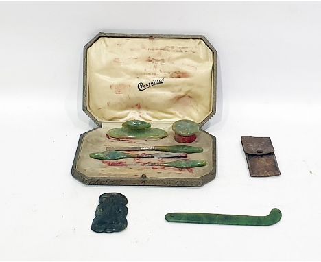 Maori anthropomorphic jade pendant Hei Tiki with red accentuated eyes, a further shaped pendant and a manicure set (3)   