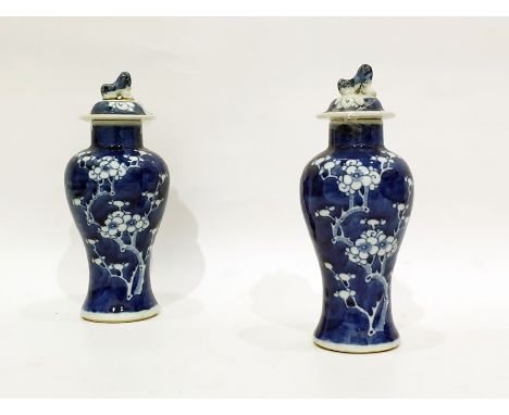 Pair of Chinese lidded baluster-shaped vases, Dog of Fo finials to the lids, the bodies decorated with allover prunus pattern