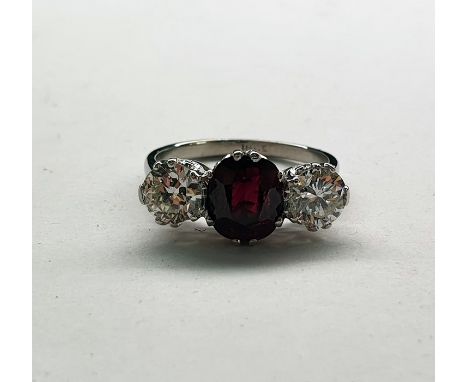 18ct gold ring set with central ruby (possibly heat treated) and two diamonds