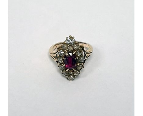 Diamond and ruby marquise ring set centre oval facet-cut ruby having surround of 14 variously sized diamonds