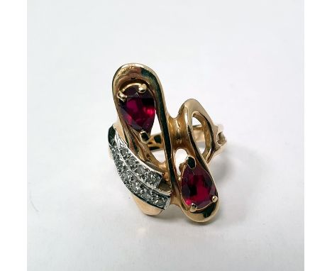 Gold dress ring set with two rows of diamonds and two pear-shaped red stones, marked '14K', size M