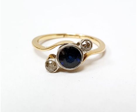 Gold, sapphire and diamond ring set central circular sapphire flanked by two smaller diamonds, in collet setting, scroll shou