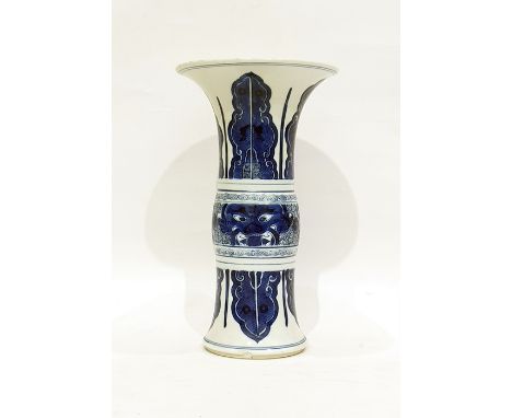 Late 19th/early 20th century Chinese vase of gu form, wide flared rim, the body decorated in blues on white with mythical hea