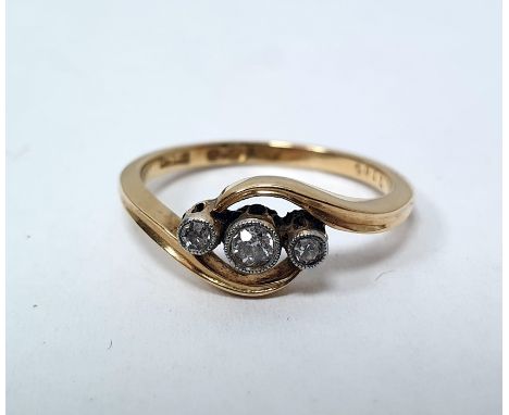 Early 20th century 18ct gold three-stone diamond ring in scroll setting, set one central and two smaller diamonds in collet s