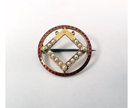 Edwardian gold brooch of circular form with a red enamel border and central square set with seedpearls, marked 15ct