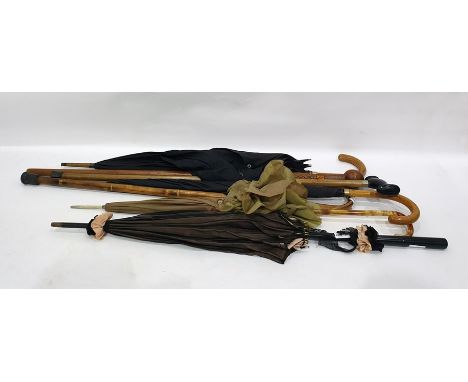 Carved wooden walking stick with knop handle, two black umbrellas, one with gold collar, the other with gold coloured collar,