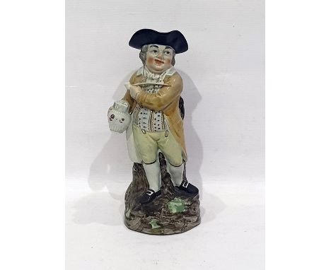19th century Toby character jug standing figure with tri-form hat, clay pipe, holding jug of ale, on rocky outcrop with mould