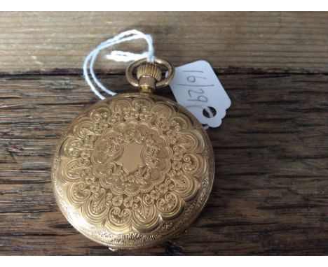 An 18ct gold fob watch with floral and scroll chased case and white enamel dial