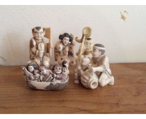 A Japanes ivory okimono and four netsuke