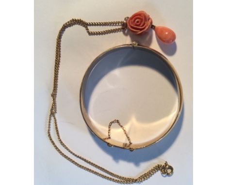 A 9ct gold bangle 16.2gms and a 9ct necklace with carved coral rose pendant