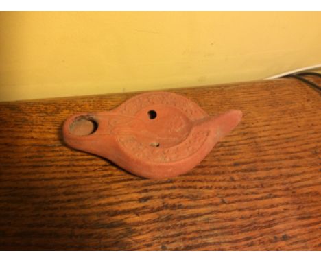 Roman redware oil lamp from Tunisia 3-5th AD decorated with pouncing lion