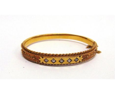 A LATE VICTORIAN DIAMOND SET HINGED BANGLE stamped '15', the five graduated diamonds, of approximately 0.3 carats total, set 