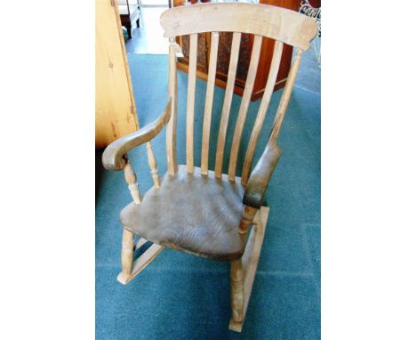 A COMB BACK WINDSOR ROCKING CHAIR,  with deep scroll arms, elm seat and H-shape stretcher (the rockers later)