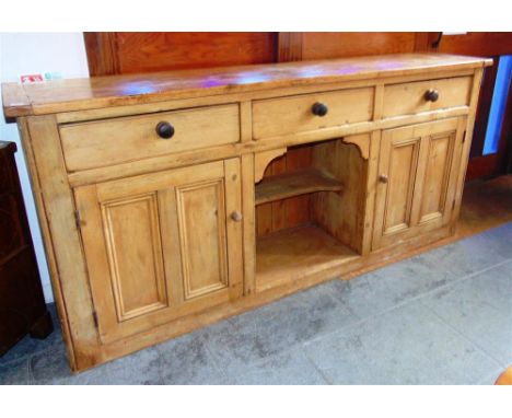 A LARGE STRIPPED PINE DRESSER BASE,  fitted with three drawers over cupboard and pot shelf, 213cm wide 48cm deep 99cm high