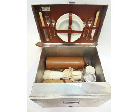 A SIRRAM PICNIC SET FOR TWO circa 1920s, comprising a large aluminium sandwich tin and container, cups, saucers, beakers, sid
