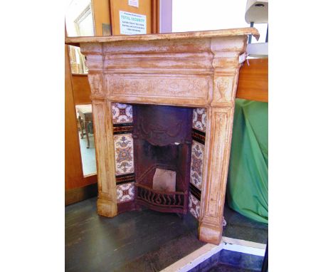 A VICTORIAN CAST IRON FIRE SURROUND AND GRATE, with tiled insert, 104cm wide 123cm high