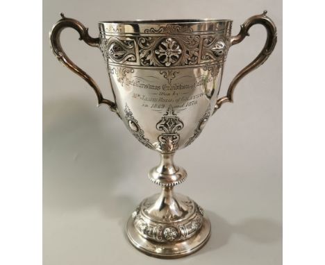 Victorian silver two handled presentation trophy cup, in Gothic design, Christmas Exhibition Cattle &amp; Co, won by Mr James