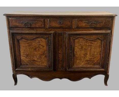 19th century French oak and walnut buffet/sideboard, the moulded top with canted angles above three moulded drawers with iron