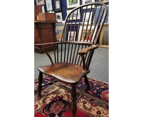 19th century, elm ash and beech stick back Windsor armchair, having solid seat on baluster turned legs and stretchers. 102cm 