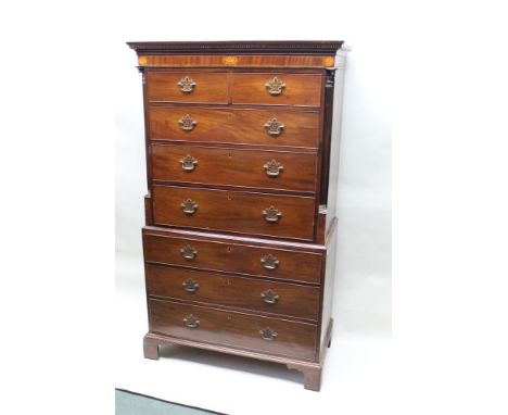 A 19th century mahogany chest on chest having dental cornice over inlaid patera frieze, the upper section having two in-line 
