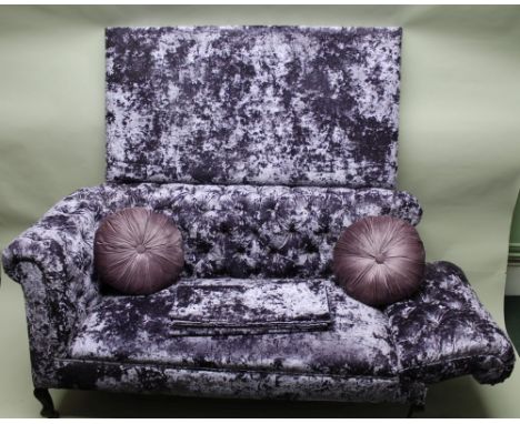 A first-quarter 20th century drop arm two-person Chesterfield in modern purple two tone upholstery, sold together with a matc