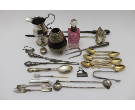 A George III silver cream jug of baluster form, with 'C' scroll handle on raised circular platform foot, London 1819, a Georg