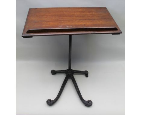 A late 19th-century adjustable mahogany topped reading table on cast metal base with ceramic castors below, 72cm wide 