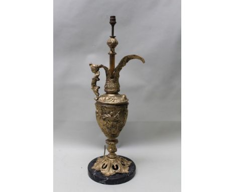 A gilded cast metal table lamp, formed as a Romanesque ewer, with mask handle, an open acanthus leaf foot raised upon a veine