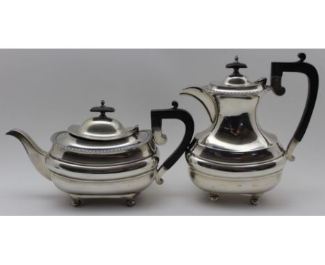 Walker &amp; Hall, A silver teapot and hot water jug, Georgian design, gadrooned rim on ball feet, Sheffield 1934, combined w