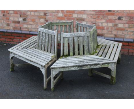 A large-size slatted teak well weathered tree trunk bench, in two sections, forming a complete 360° unit, 88cm high x 230cm d