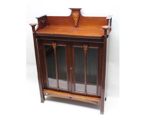 A late 19th / early 20th century art nouveau designed mahogany bookcase unit, with fancy three-quarter up stand with inlaid s