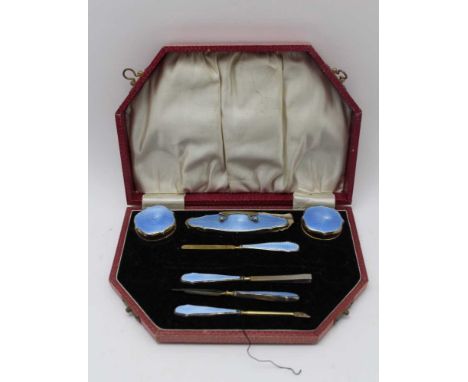 An early 20th century cased silver gilt and blue guilloche enamel manicure set, Birmingham 1927 (two pairs of scissors missin