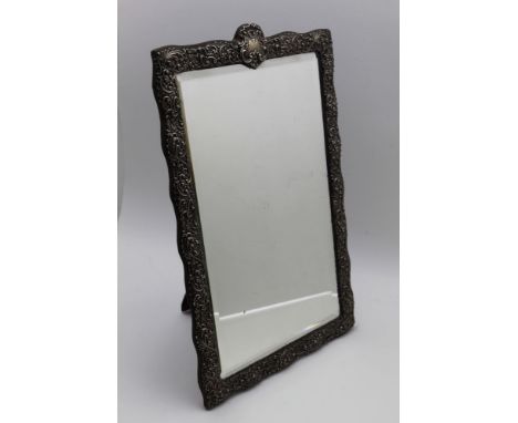 Henry Matthews, a late Victorian embossed silver framed dressing table mirror, floral &amp; acanthus leaf decoration, bevel p