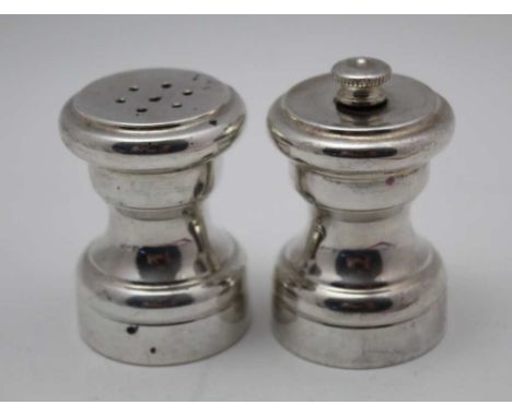 A pair of 'sterling' silver capstan design condiments, comprising a salt &amp; pepper grinder (2) 