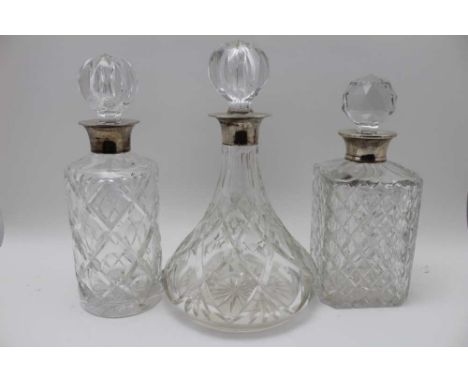 A collection of three silver collar, cut glass decanters, with stoppers, one square form spirit decanter, marked for Mappin &