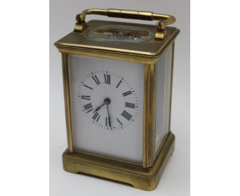 A 20th Century French Brass Framed Carriage Clock, with white dial, having Roman numerals, bevel glass panels in the round, h