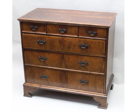 A 19th-century walnut fronted chest, having unfinished top over three in-line drawers and three further full-width graduating