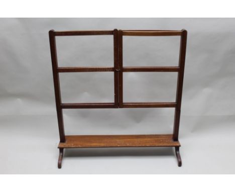A first quarter 20th century folding mahogany towel rail, on plain supports united by a plank undertier on four downswept leg