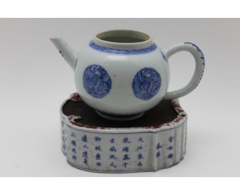 An 18th century Chinese porcelain bullet form teapot, cobalt blue decoration, 8cm high, together with a teapot stand decorate