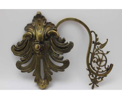 An early 20th century cast brass gas light fitting, to include a scrolling Rococo wall bracket 